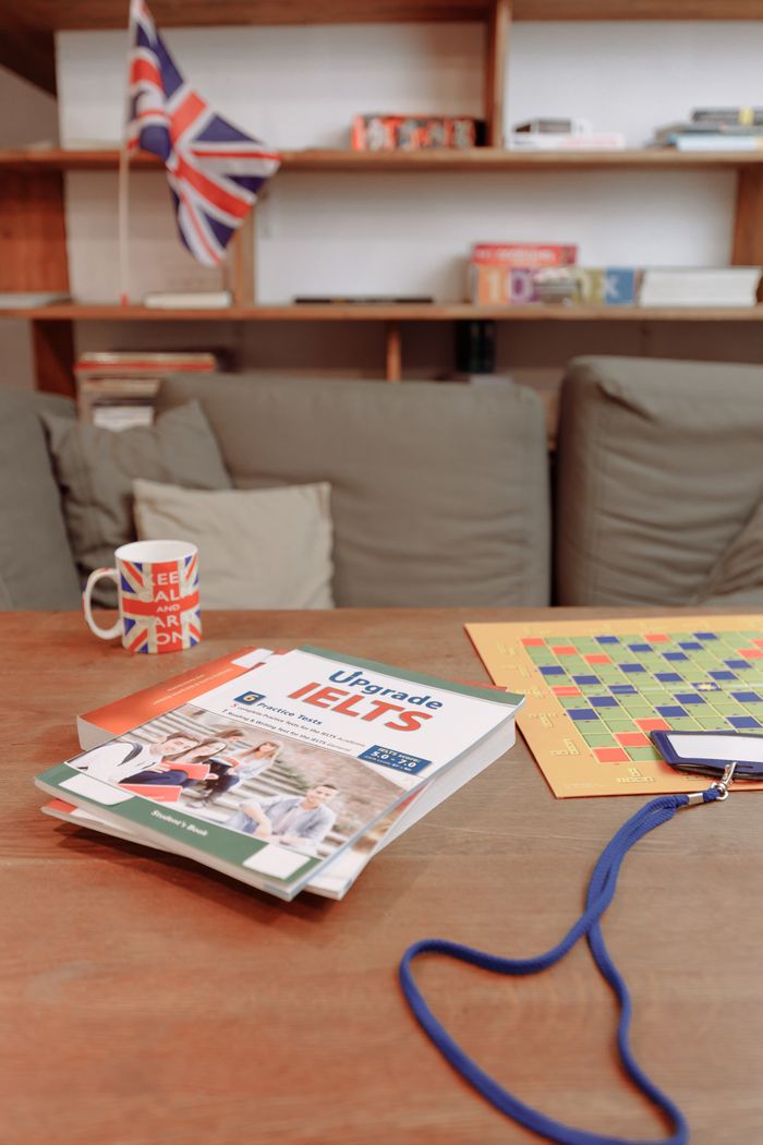 our-experience IELTS prep materials on a coffee table with a British flag mug and decor. Ideal for education themes.